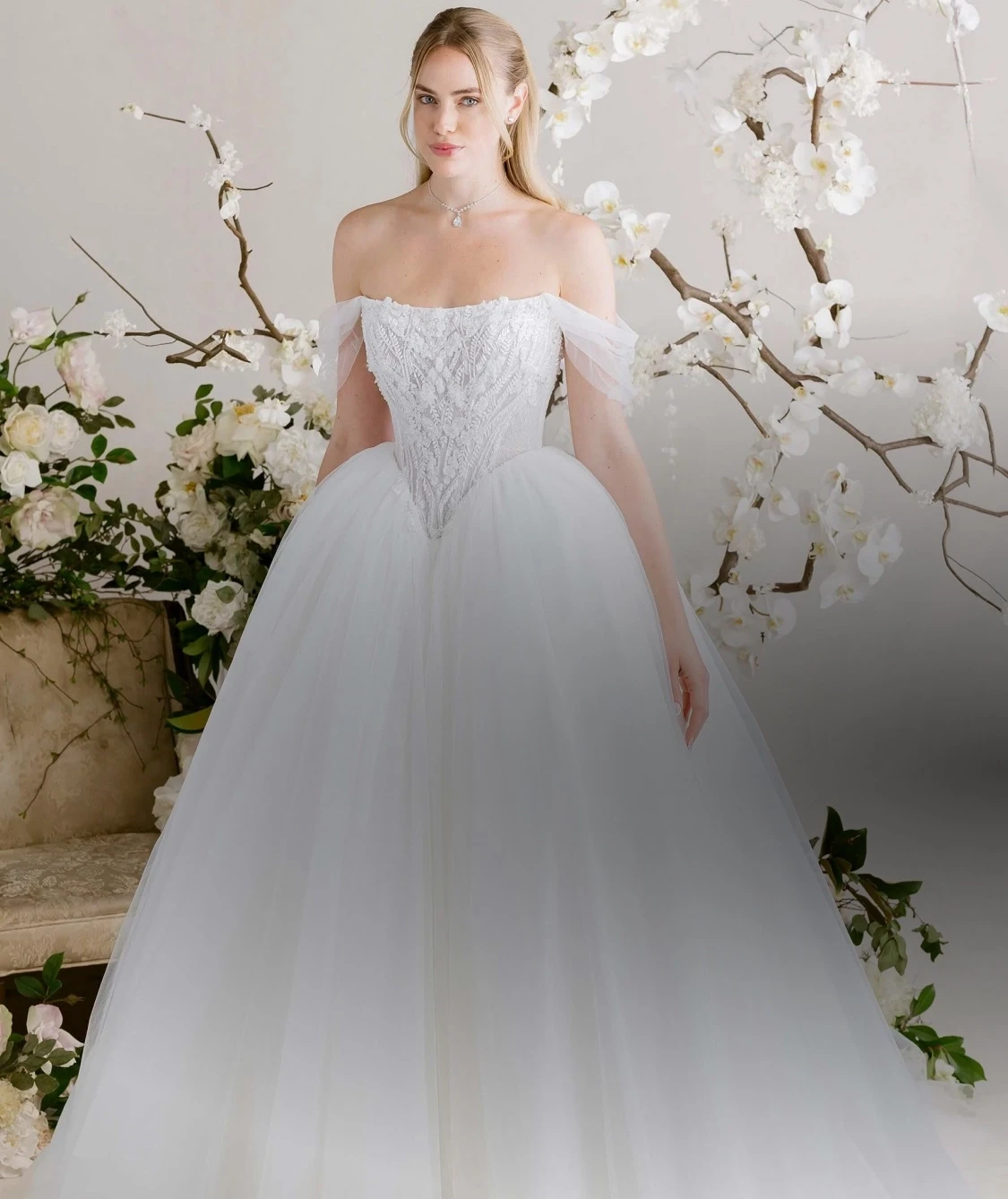Model wearing white dresses by Mori Lee Spring 2025. Mobile Image