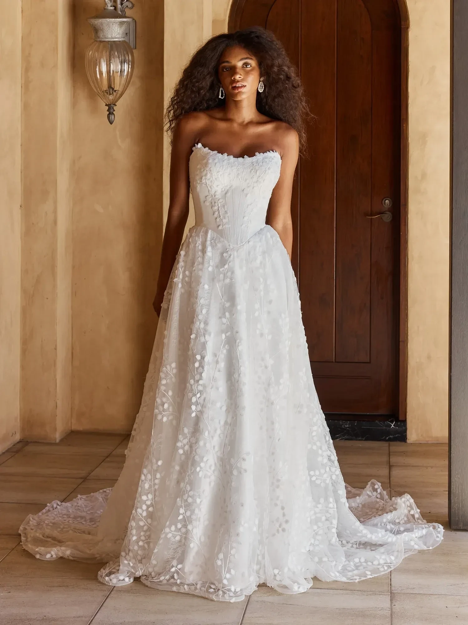 Model wearing a white gown. Mobile image